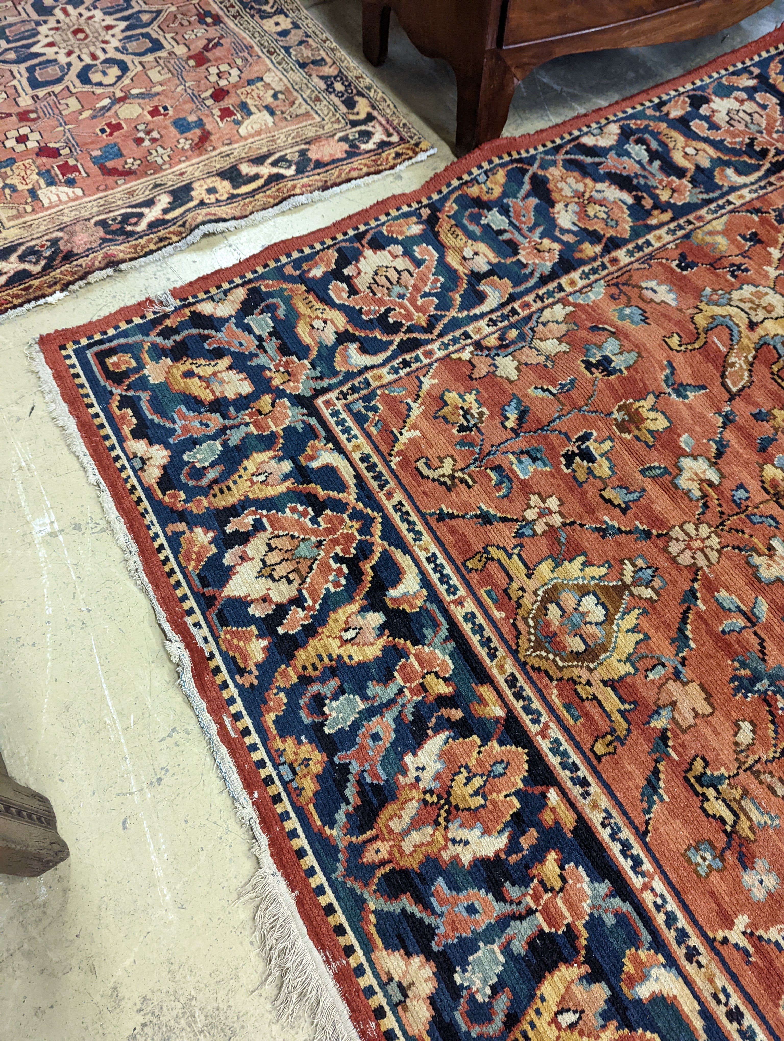 A Persian style machined brick red ground carpet (severely worn), 392 x 286cm